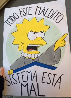 a person holding up a sign with the simpsons saying, too ese madio sistema esta mal