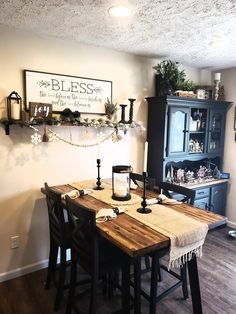 a dining room table and chairs with a sign on the wall above it that says blessing