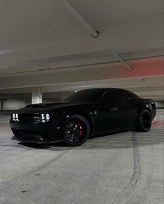 a black car parked in a parking garage