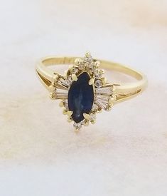 Buy 14k Yellow Gold Sapphire and Diamond Ring Online in India - Etsy Formal Cluster Gemstones Fine Jewelry, Gold Marquise Gemstone Wedding Jewelry, Marquise Gemstone Diamond Ring In 14k Gold, 14k Gold Marquise Diamond Ring With Gemstone, Elegant Cluster Gemstones For Formal Occasions, 14k Gold Cluster Ring With Baguette Cut Center Stone, Fine Jewelry Baguette Cut Gemstones For Anniversary, Classic Yellow Gold Gemstones With Diamond Accents, Fine Jewelry Marquise Cluster Ring With Accent Stones