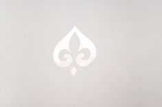 a white fleur de lis logo on a gray background