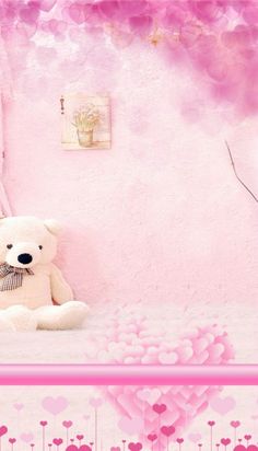 a white teddy bear sitting on top of a bed next to a pink wall with hearts