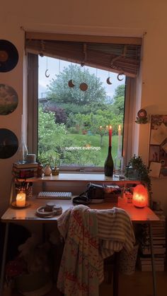 a room with a large window that has candles on it