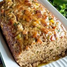 a loaf of meat sitting on top of a white plate