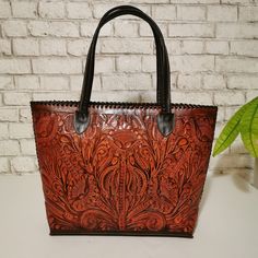 Leather Tote bag crafted from genuine cowhide leather.  -Each  Tote bag is individually handmade with great care and precision, ensuring a unique and high-quality design. -The chiseled leatherwork provides an elegant, timeless look that will never go out of style. The perfect size for fitting all of your belongings. -The floral designs are intricately carved into the leather, making each bag a one-of-a-kind masterpiece.  height:31 cm. - 12 inches. width at the bottom: 35cm. -14 inches width at t Traditional Hand Tooled Bags For Everyday Use, Traditional Hand-tooled Bags For Everyday Use, Traditional Hand Tooled Bags, Traditional Hand Tooled Bag For Daily Use, Traditional Hand-tooled Bag For Daily Use, Traditional Hand-tooled Tote Bag, Leather Bag With Engraved Details For Everyday Use, Engraved Leather Bag For Everyday Use, Leather Bag With Engraving For Everyday Use