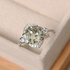 This halo ring features a 7*9mm oval cut natural green amethyst and sterling silver finished with rhodium. Customization is available. It is made by hand, and it will take about 7 days to finish the ring after your payment is completed. Any question, just let me know. :) My shop homepage: https://www.etsy.com/shop/LuoJewelry?ref=l2-shopheader-name Green Amethyst Engagement Ring, Emerald Cut Solitaire Ring, Amethyst Engagement Ring, Fine Engagement Rings, Pear Cut Engagement Rings, Green Amethyst Ring, Oval Cut Engagement Ring, Cushion Cut Engagement Ring, Emerald Engagement Ring Cut