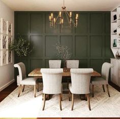 a dining room with green walls and white chairs