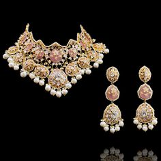 Pull off an ethnic look with a dash of modernity in this stunning piece! The look includes necklace, earrings, a pair of saharay and a maang teekah. This beautiful set is decked out in CZ stones and accented with pink stones and white pearls. Beautify your look with perfectly matched earrings along with a pair of white pearl moti saharay and a stunning maang teekah. Approximate earrings length is 4". Gold-plated on high-quality brass as base metal. Made by order. Kindly allow 5-7 weeks for the d Chandbali Stone Work Jewelry Sets For Designer Wear, Bollywood Style Designer Jewelry Sets With Stone Work, Elegant Pink Kundan Jewelry Sets, Elegant Pink Kundan Sets, Bollywood Style Jewelry Sets With Stone Work, Festive Pink Pearl Necklace For Wedding, Designer Kundan Jeweled Jewelry, Pink Kundan Jewelry With Intricate Design, Designer Wear Jeweled Jewelry For Diwali