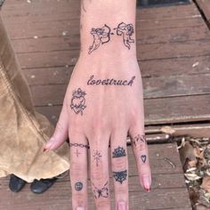 a person's hand with tattoos on it