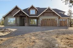 a large house with two garages and lots of windows on the front of it