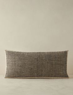 a rectangular pillow on a white surface