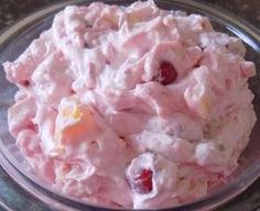 a bowl filled with fruit salad on top of a table