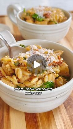 two bowls filled with pasta and cheese on top of a wooden table