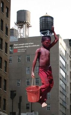 a man is jumping in the air with a bucket on his head