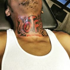 a man with a tattoo on his neck has the word stop painted on his chest