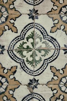 an old tile floor with decorative designs on it's sides and the top part of the tiles