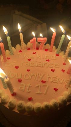 a birthday cake with lit candles on it