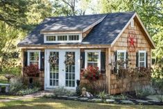 a small wooden house sitting in the middle of a forest