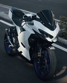 a white and black motorcycle parked on the street