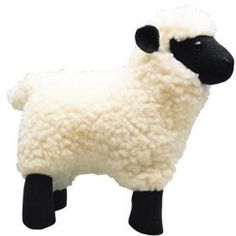 a black and white sheep toy on a white background