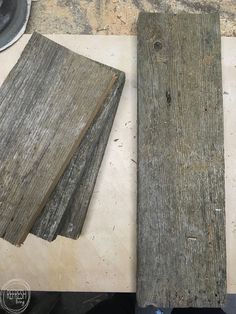 two pieces of wood sitting on top of a table