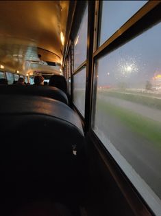 the view from inside a bus on a foggy day with fireworks in the sky