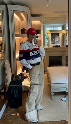 a man is taking a selfie in front of a closet with an open door