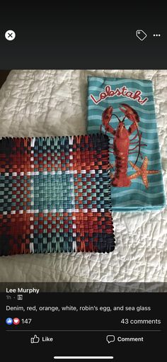 two quilts are laying on top of a bed with the words lobster written in red, orange, white, and blue