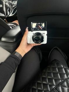 a person holding a camera in their car