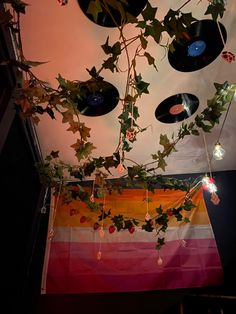 vinyl records are hanging from the ceiling with ivy