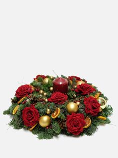 a christmas wreath with red roses and gold ornaments