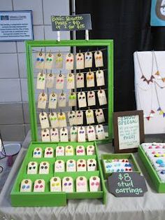 a table topped with lots of different types of jewelry on display next to each other