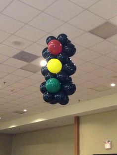 some balloons are hanging from the ceiling in an office