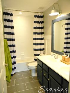 a bathroom with black and white striped curtains