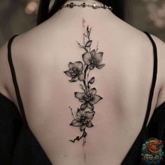 the back of a woman's neck with flowers on it