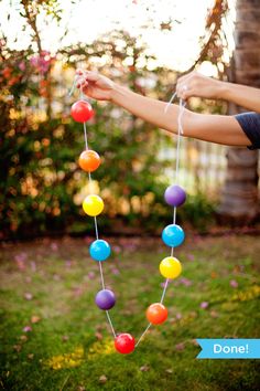 a person holding a string with balls attached to it