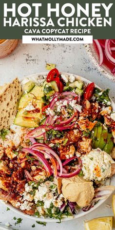 a white plate topped with chicken and veggies next to tortilla chips