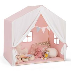 a pink play tent with stuffed animals in it