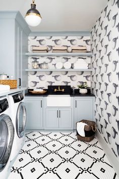 a washer and dryer in a room with wallpaper on the walls behind them