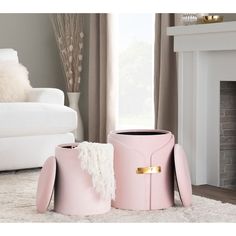 two pink vases sitting on top of a white rug in front of a fireplace