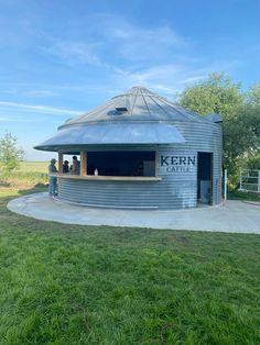 an outdoor kiosk in the middle of a field