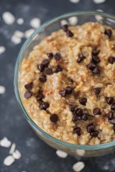 a bowl filled with oatmeal and chocolate chips on top of a table