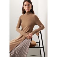 Brown knit (90% Wool, 10% Cashmere). A-line. Long sleeves. Turtleneck. Pull on. 45" from shoulder to hemline. Imported. Chic Beige Turtleneck Dress, Elegant Knee-length Sweater For Spring, Fitted Beige Dress For Layering, Casual Midi Dress For Fall Layering, Casual Fall Midi Dress For Layering, Chic Brown Stretch Sweater Dress, Beige Dress For Layering In Fall, Beige Dress For Fall Layering, Elegant Fitted Beige Sweater