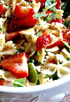 a white bowl filled with pasta and strawberries