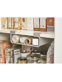 the shelves are filled with various items and containers for food, such as rolls or cereals