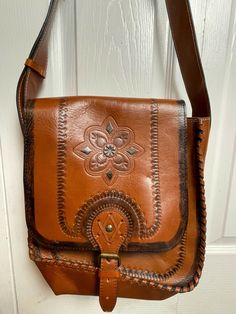 Patricia Nash hand tooled satchel cross body bag measures 13" high by 12" wide, adjustable strap 20" long with an extra 7" for longer length.  Condition, is excellent inside and out like new even has the new leather smell.  This is a very large satchel bag. Dust Bag included. Please make sure to look at photos of the product as I will NOT issue any refunds, returns or exchanges. Thank you Brown Pouch Shoulder Bag With Coin Pocket, Vintage Saddle Bag Tote With Removable Pouch, Travel Shoulder Bag With Coin Pocket, Vintage Crossbody Bag With Removable Pouch, Rectangular Brown Shoulder Bag With Coin Pocket, Satchel Bag With Coin Pocket, Brown Rectangular Shoulder Bag With Coin Pocket, Brown Shoulder Bag Satchel With Coin Pocket, Brown Crossbody Shoulder Bag With Coin Pocket