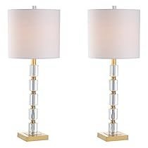 pair of modern glass and brass table lamps with white linen shades on each lamp base