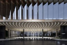 the entrance to an office building with large glass doors and intricate patterns on the facade