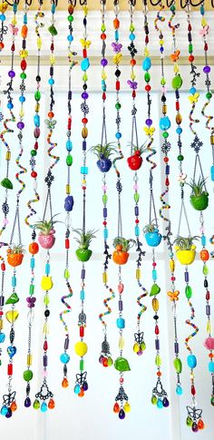 a bunch of colorful beads hanging from a window