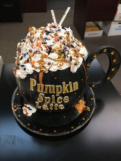 there is a cake in the shape of a coffee cup that says pumpkin spice time